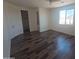 Bright bedroom with an en suite bathroom, closet, mountain views, and wood-look flooring at 5826 W Plum Rd, Phoenix, AZ 85083