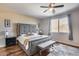 Bedroom with a gray bed frame, bench, and hard wood floors at 5826 W Plum Rd, Phoenix, AZ 85083