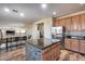 Spacious kitchen with a central island featuring barstool seating and stainless steel refrigerator at 5826 W Plum Rd, Phoenix, AZ 85083