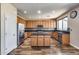 Well-equipped kitchen featuring wooden cabinets, black granite countertops, and stainless steel appliances at 5826 W Plum Rd, Phoenix, AZ 85083