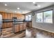 Well-lit kitchen featuring wooden cabinets, dark granite countertops, and stainless steel appliances at 5826 W Plum Rd, Phoenix, AZ 85083
