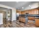 An open concept kitchen featuring a granite island, ample cabinet space, and stainless steel appliances at 5826 W Plum Rd, Phoenix, AZ 85083