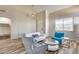 Cozy living room featuring wood floors, neutral furniture, and ample natural light at 5826 W Plum Rd, Phoenix, AZ 85083