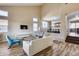 Bright living room featuring high ceilings, wood floors, and contemporary furnishings at 5826 W Plum Rd, Phoenix, AZ 85083