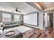 The living room features a large screen, comfy seating, and wood floors, perfect for movie nights at 5826 W Plum Rd, Phoenix, AZ 85083