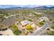 Scenic aerial of neighborhood with a home that has a solar panel roof, desert landscaping, and a private pool at 5978 E Chuckwalla Trl, Cave Creek, AZ 85331