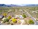 Scenic aerial of neighborhood with a home that has a solar panel roof, desert landscaping, and a private pool at 5978 E Chuckwalla Trl, Cave Creek, AZ 85331
