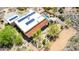 Desert home with solar panels and a pool on a sunny day, as seen in this aerial shot at 5978 E Chuckwalla Trl, Cave Creek, AZ 85331