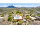 A high angle aerial view of a desert home with solar panels and a pool, in a sunny location at 5978 E Chuckwalla Trl, Cave Creek, AZ 85331