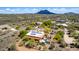 An aerial view of a desert home with solar panels, a pool, and mountain views on a sunny day at 5978 E Chuckwalla Trl, Cave Creek, AZ 85331