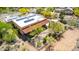 Stunning aerial view of a desert home with solar panels and a spacious fenced yard surrounded by lush greenery at 5978 E Chuckwalla Trl, Cave Creek, AZ 85331