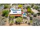A sunny aerial view of a desert home with a pool, covered patio, and solar panels on the roof at 5978 E Chuckwalla Trl, Cave Creek, AZ 85331