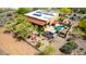 Desert home features pool, solar panels, patio with pergola, and outdoor firepit with desert landscaping at 5978 E Chuckwalla Trl, Cave Creek, AZ 85331