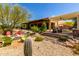 Expansive backyard featuring desert landscaping, a fire pit, and a covered patio with comfortable seating at 5978 E Chuckwalla Trl, Cave Creek, AZ 85331