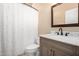 Clean bathroom with marble countertop and shower with patterned curtain at 5978 E Chuckwalla Trl, Cave Creek, AZ 85331