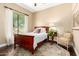Bright bedroom featuring a wood-frame bed, large window, and natural light at 5978 E Chuckwalla Trl, Cave Creek, AZ 85331