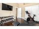 Home gym with mounted television, exercise bike, and weight rack at 5978 E Chuckwalla Trl, Cave Creek, AZ 85331