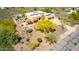 Aerial view of home featuring a swimming pool, two-car garage, desert landscaping, and a solar-paneled roof at 5978 E Chuckwalla Trl, Cave Creek, AZ 85331
