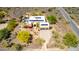 Aerial view of inviting desert home with pool, two-car garage, desert landscaping, and solar-paneled roof at 5978 E Chuckwalla Trl, Cave Creek, AZ 85331