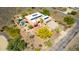 Aerial view of home with pool, two-car garage, desert landscaping, and solar-paneled roof at 5978 E Chuckwalla Trl, Cave Creek, AZ 85331