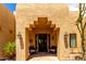 Inviting front entry with barrel tile accents, hanging lanterns and desert landscaping at 5978 E Chuckwalla Trl, Cave Creek, AZ 85331