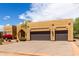 Single story home featuring desert landscaping with blooming flowers, and an attached two-car garage at 5978 E Chuckwalla Trl, Cave Creek, AZ 85331