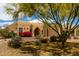 Single story home featuring desert landscaping with blooming flowers, and mature trees at 5978 E Chuckwalla Trl, Cave Creek, AZ 85331