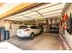 Well-organized garage with ample storage space, car, and various shelving units, catering to practical needs at 5978 E Chuckwalla Trl, Cave Creek, AZ 85331