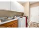 Laundry room featuring modern washer and dryer with sink and overhead cabinets at 5978 E Chuckwalla Trl, Cave Creek, AZ 85331