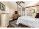 Spacious main bedroom with a four-poster bed, wooden floors, and neutral decor at 5978 E Chuckwalla Trl, Cave Creek, AZ 85331