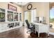 Bright home office with custom built-ins, hardwood floors, and a window overlooking desert landscaping at 5978 E Chuckwalla Trl, Cave Creek, AZ 85331