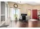 Home office with hardwood floors, a window overlooking desert landscaping, and a bright red front door at 5978 E Chuckwalla Trl, Cave Creek, AZ 85331