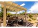 Inviting outdoor kitchen featuring a built-in grill, pergola, and comfortable seating area, perfect for entertaining at 5978 E Chuckwalla Trl, Cave Creek, AZ 85331