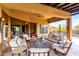 Spacious covered patio featuring stylish furniture and views of the backyard pool at 5978 E Chuckwalla Trl, Cave Creek, AZ 85331
