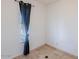 Bright bedroom corner with a window and decorative curtain over tile flooring at 6130 N 12Th Way, Phoenix, AZ 85014