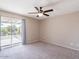 Bedroom with ceiling fan, neutral carpet, and sliding door to a private balcony with views at 6130 N 12Th Way, Phoenix, AZ 85014