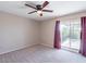 Bedroom with ceiling fan, neutral carpet, and sliding door to a private balcony with views at 6130 N 12Th Way, Phoenix, AZ 85014