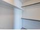 Walk-in closet with white shelves and rods, providing ample storage space at 6130 N 12Th Way, Phoenix, AZ 85014