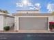 View of the garage with beautiful flowering shrubs. Number 6130 clearly visible at 6130 N 12Th Way, Phoenix, AZ 85014
