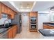 Bright kitchen featuring updated stainless steel appliances, wood cabinets, and granite countertops at 6130 N 12Th Way, Phoenix, AZ 85014