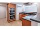 This kitchen features wooden cabinets, granite countertops, and stainless steel oven set at 6130 N 12Th Way, Phoenix, AZ 85014
