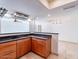 Cozy kitchen featuring wood cabinets and granite countertops with an open floor plan at 6130 N 12Th Way, Phoenix, AZ 85014