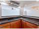 Kitchen with a granite countertop, wooden cabinets, and modern appliances at 6130 N 12Th Way, Phoenix, AZ 85014