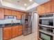 Modern kitchen with stainless steel appliances and wood cabinetry, offering ample storage at 6130 N 12Th Way, Phoenix, AZ 85014