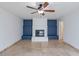 Living room featuring a fireplace, a ceiling fan, and neutral colors at 6130 N 12Th Way, Phoenix, AZ 85014