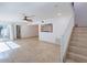 Spacious living room featuring tiled flooring, sliding glass doors, and staircase at 6130 N 12Th Way, Phoenix, AZ 85014