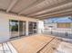 This covered patio features a wooden deck, sliding glass doors, and a wrought iron railing at 6130 N 12Th Way, Phoenix, AZ 85014