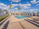 Beautiful community pool with lounge chairs and palm trees under a bright sky at 6130 N 12Th Way, Phoenix, AZ 85014
