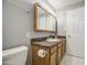 Bathroom featuring a granite vanity and mirror with vanity lights at 6939 W Cambridge Ave, Phoenix, AZ 85035