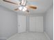 Bedroom featuring tile floors, ceiling fan, and closet with doors at 6939 W Cambridge Ave, Phoenix, AZ 85035